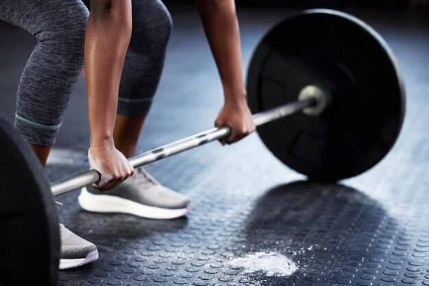 A lifter setting their grip on a loaded barbell